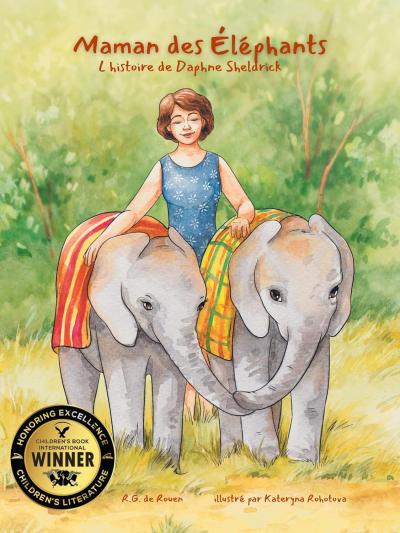 A woman smiles gently, walking between two baby elephants draped in colorful cloths. A "Children's Book Winner" seal is displayed. The tone is warm and nurturing.